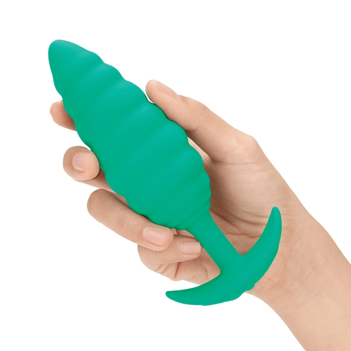 A green silicone anal plug with a twisted texture and flared base.