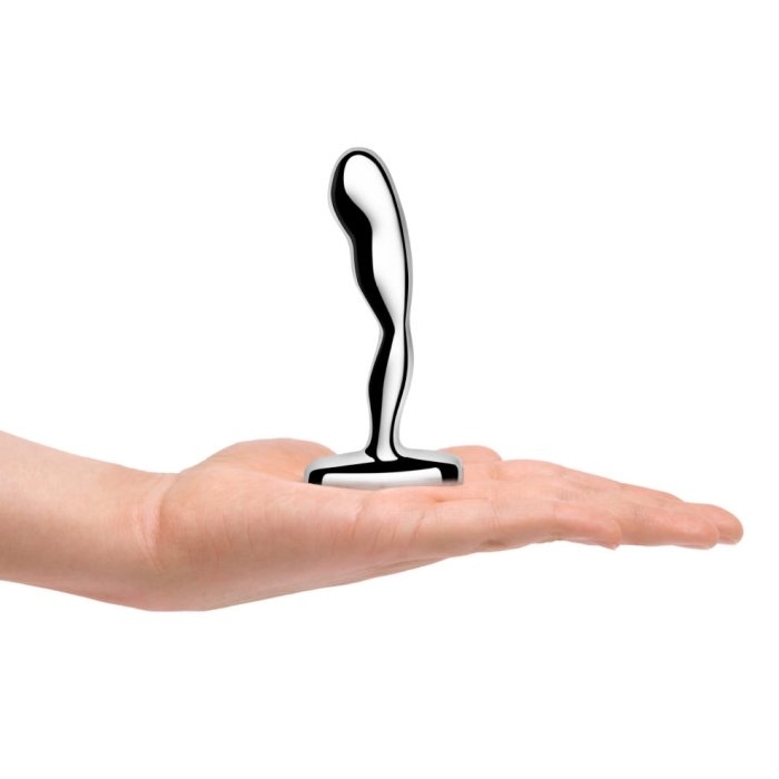 Curved stainless steel prostate plug resting on an open palm.