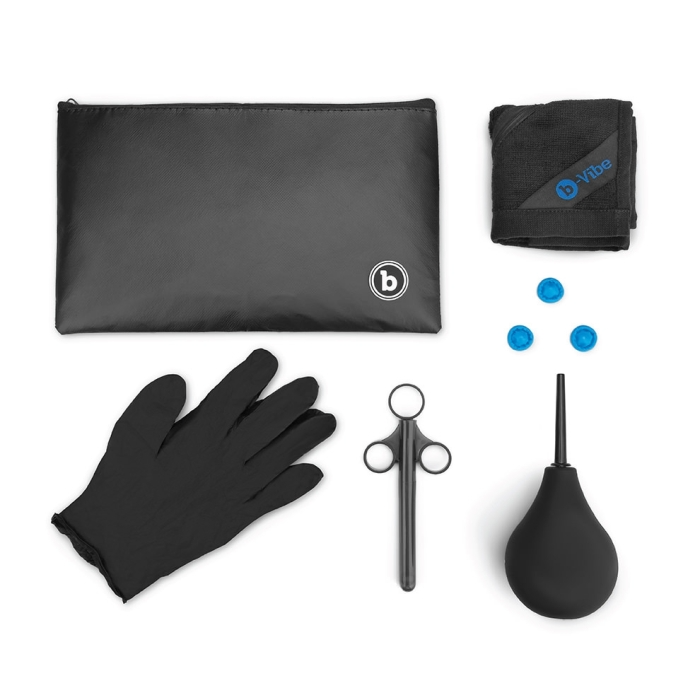 Anal massage and education set with black pouch, glove, tweezers, cloth, and blue plugs.