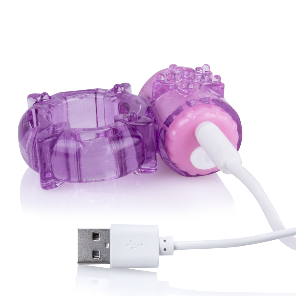 Purple vibrating cock ring with USB charging cable.
