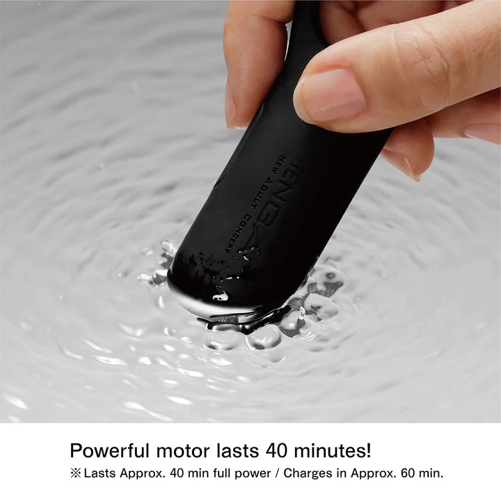 A black Tenga vibrating cock ring submerged in water.