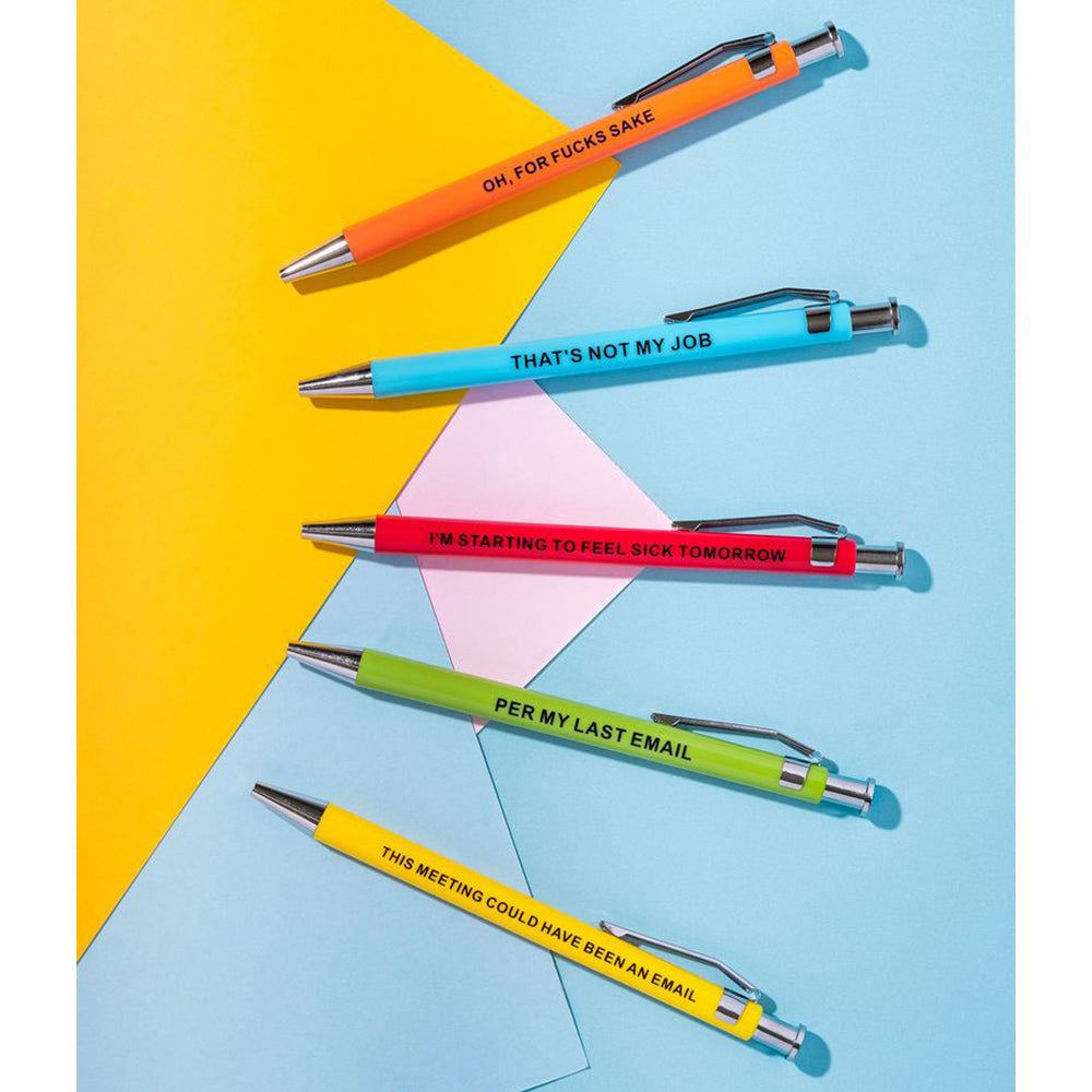 Five novelty ballpoint pens with humorous phrases on a colorful background.