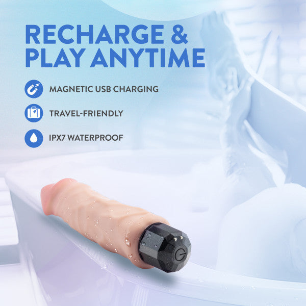 A realistic, waterproof vibrating dildo with a black base rests on the edge of a bathtub.