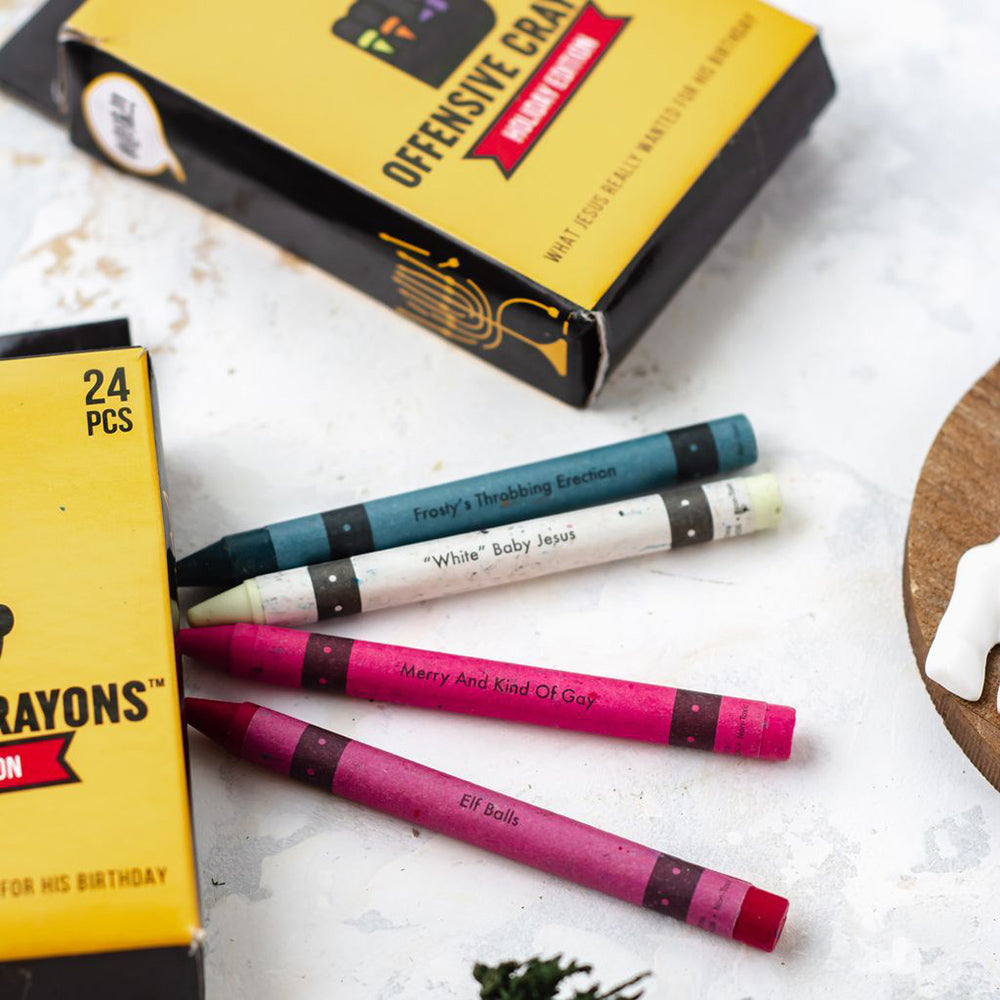 Offensive Holiday Crayons with humorous names on a white surface.