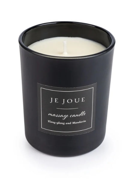 Black massage candle with a label that says "JE JOUE massage candle Ylang-ylang and Mandarin".