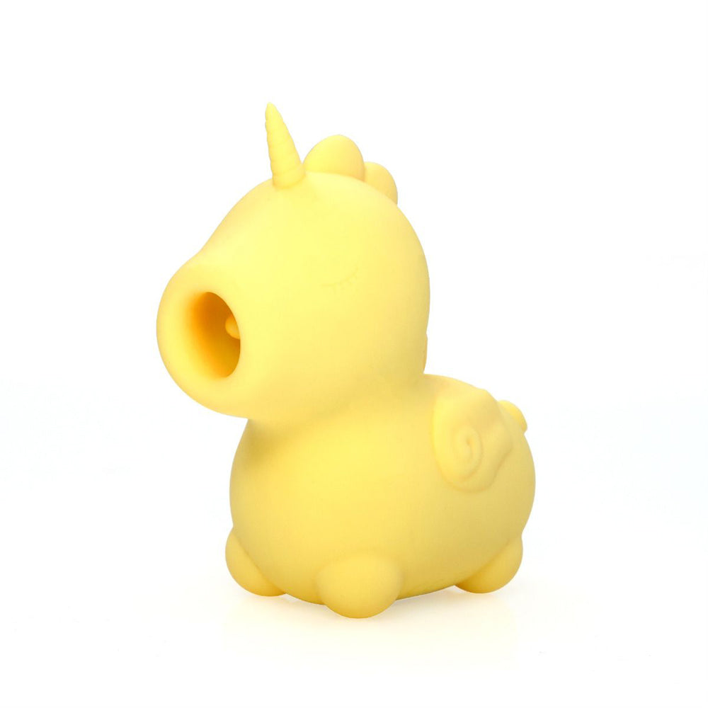 Yellow unicorn-shaped silicone tongue vibrator with a horn and open mouth.