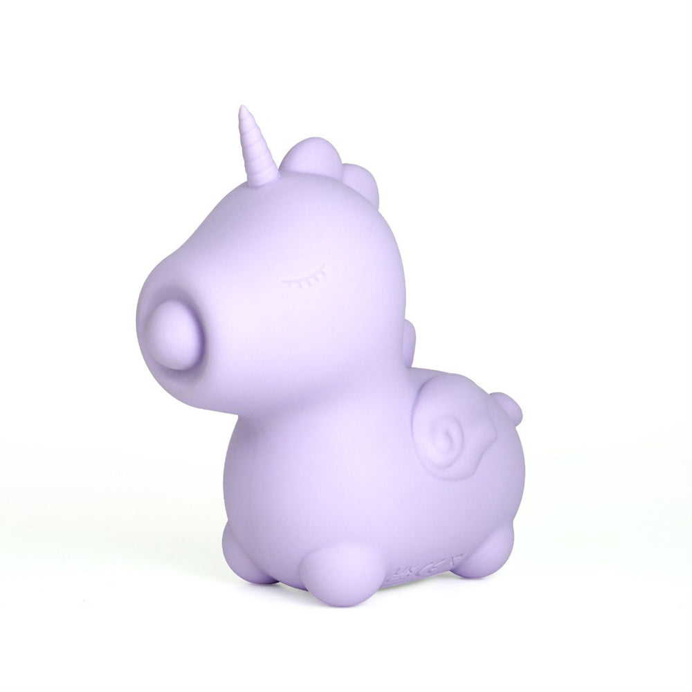 Lilac unicorn-shaped silicone vibrator with closed eyes and a horn.