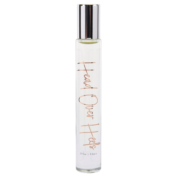 A clear glass roll-on perfume bottle with a silver cap, labeled "Head Over Heels".