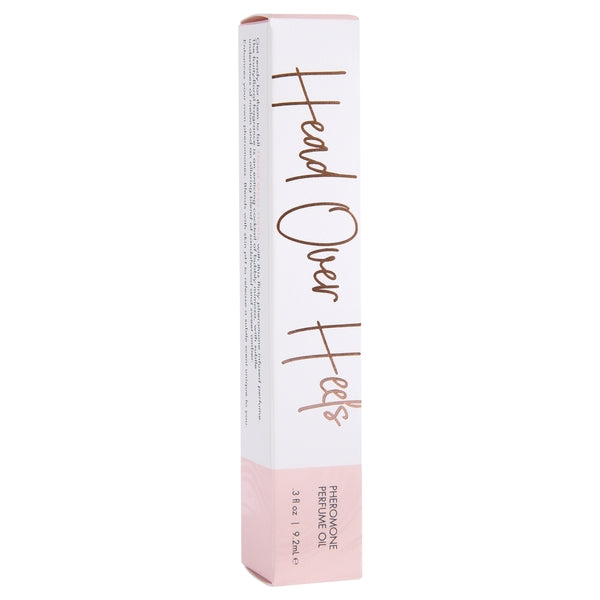 A white box with "Head Over Heels" and "Pheromone Perfume Oil" printed on it.