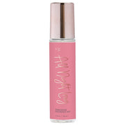 A pink bottle of "All Night Long" pheromone fragrance mist with a rose gold cap.