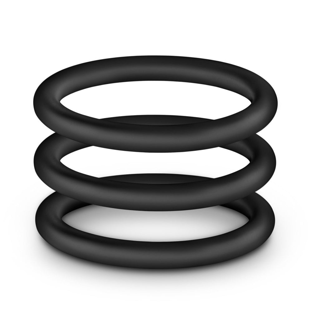 Three black silicone rings stacked on a white background.