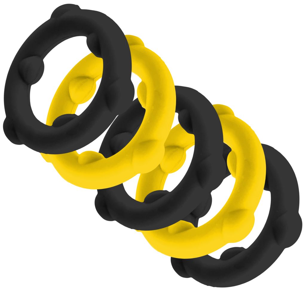 Four silicone spinner cock rings, two yellow and two black, are arranged in a diagonal line.