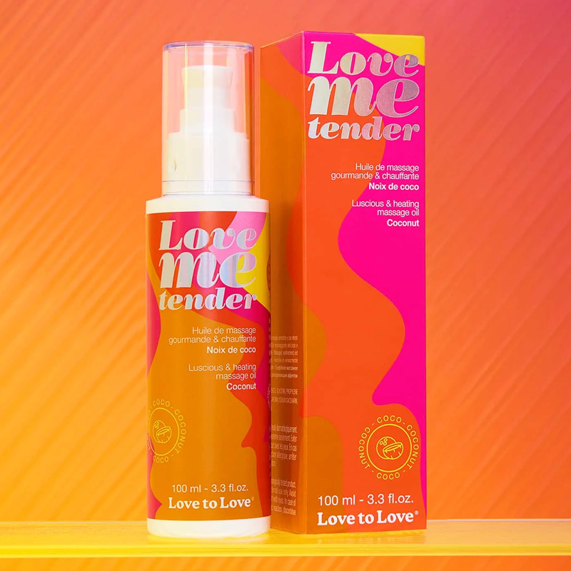 Coconut warming massage oil bottle and box with vibrant orange and pink design.