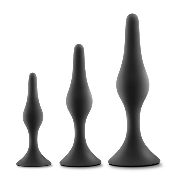Three black silicone anal plugs of graduated sizes.