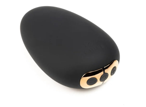 Black vibrator with gold accents and buttons.