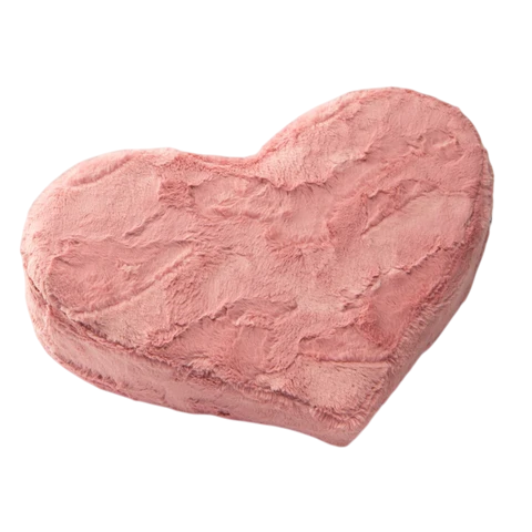 A rose faux fur heart-shaped wedge pillow.