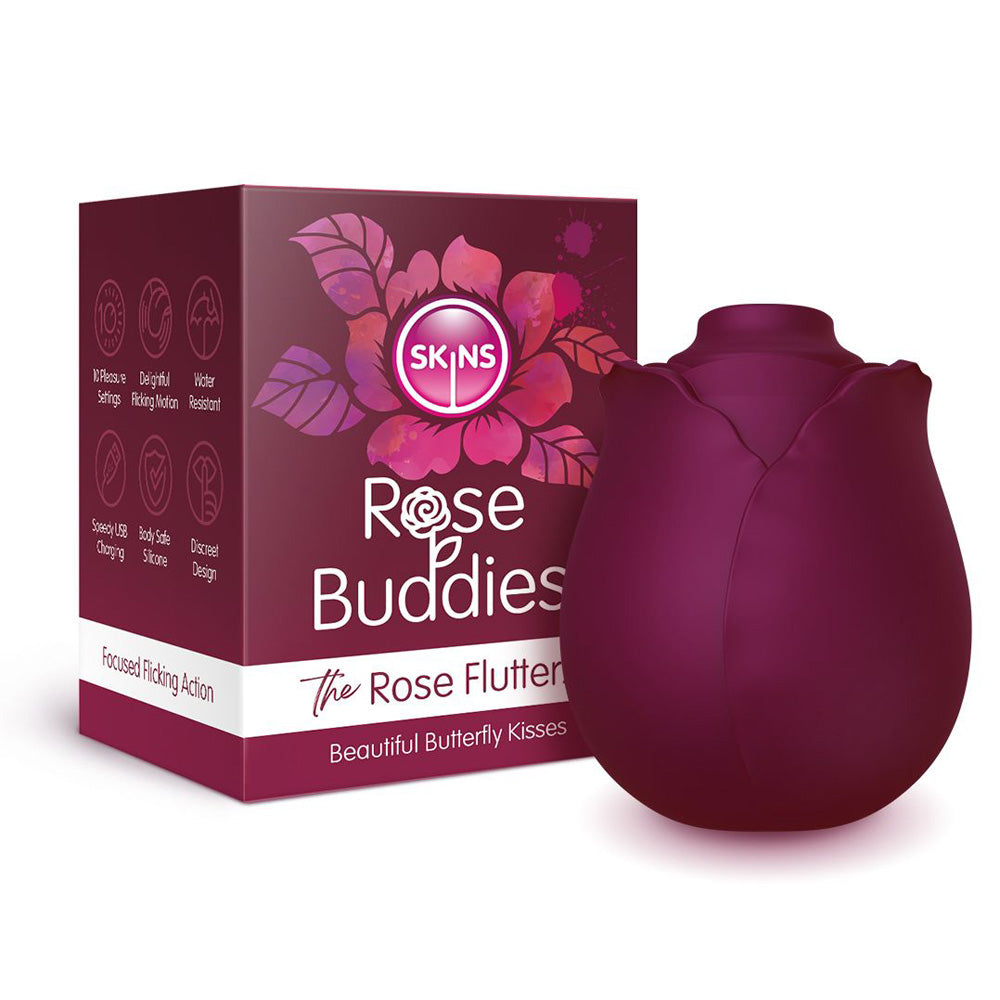 A purple rose-shaped clitoral vibrator with the brand name "Skins Rose Buddies" on the box.