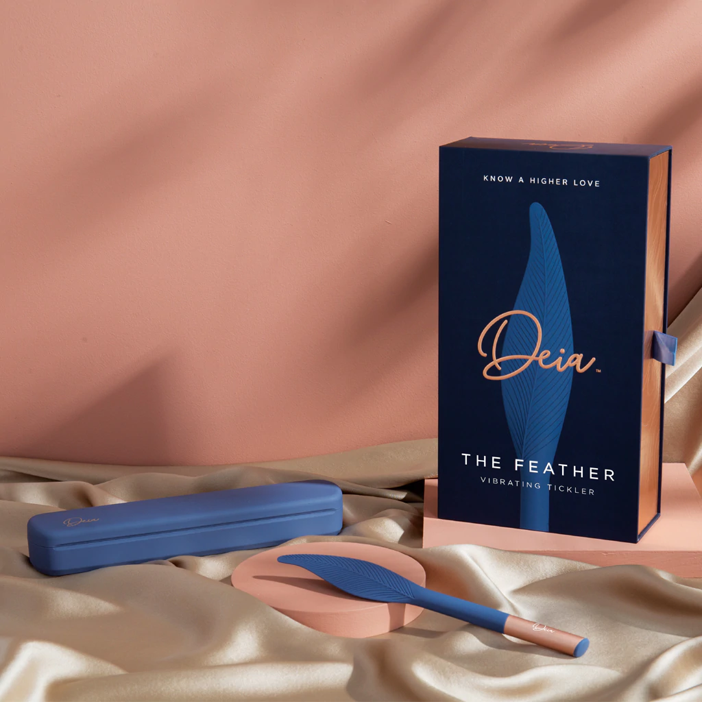 A blue silicone vibrating feather teaser with a charging case.