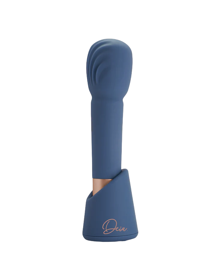 Blue rechargeable silicone massage wand with a textured head and charging stand.