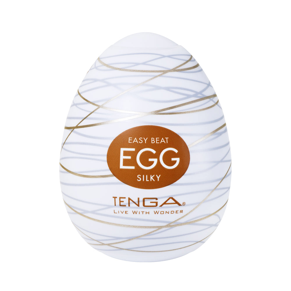 Tenga Silky Male Masturbator Egg with gold wavy lines and brown label.