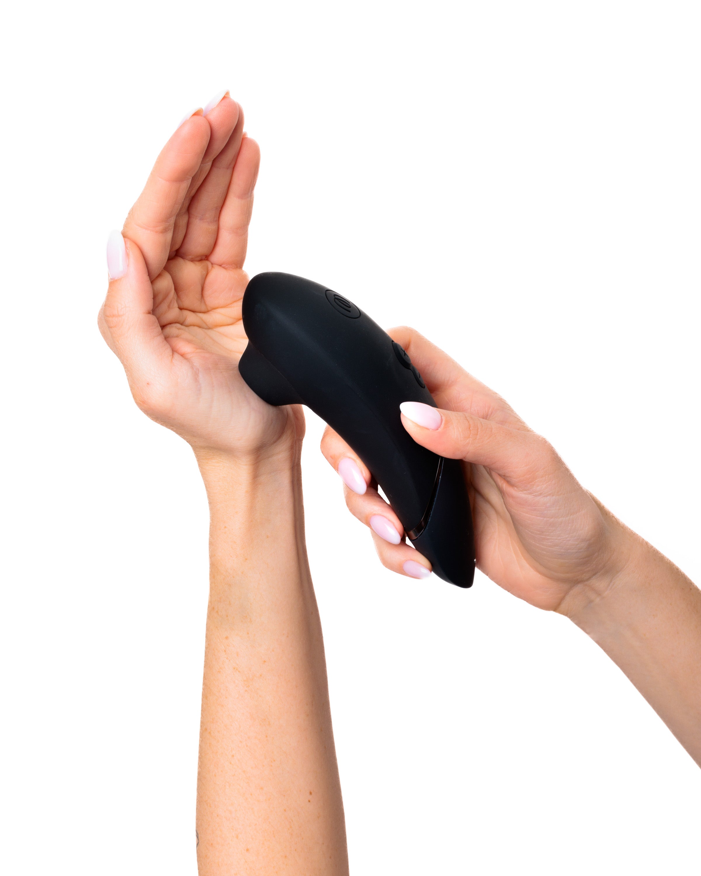 A black vibrator held by a woman's hands.