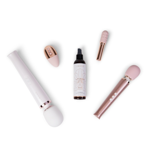 A white and rose gold wand, a pink and rose gold wand, a small pink vibrator, and a bottle of intimate toy cleaner.