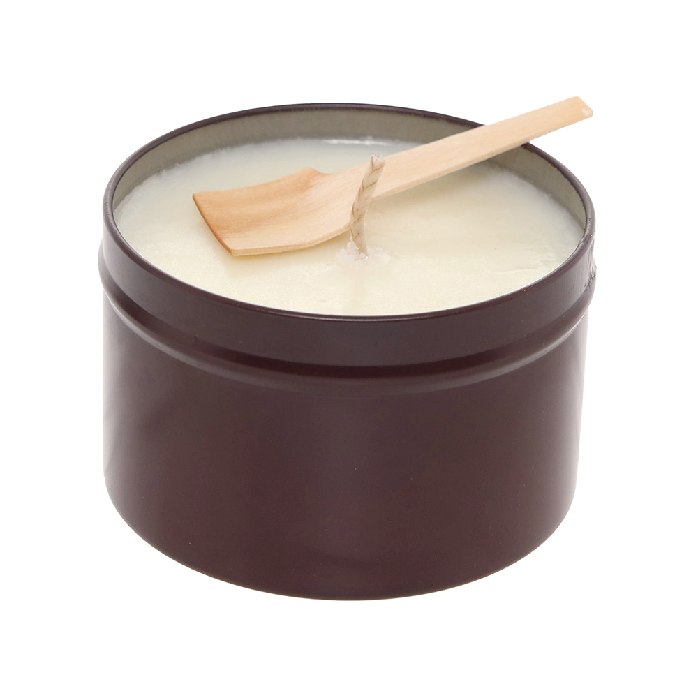 A brown tin candle with a wooden wick and a wooden spoon.