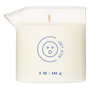 A white massage oil candle in a glass beaker with a blue logo and text.