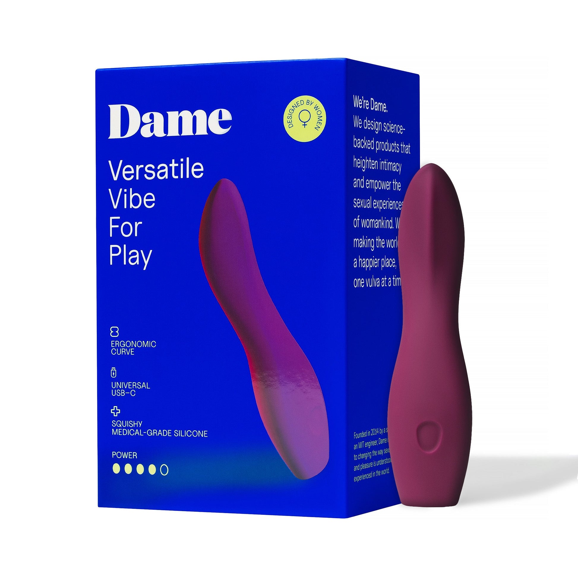 A plum-colored Dame Dip 2.0 vibrator with a curved ergonomic shape on a blue box.