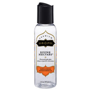 Kama Sutra Tropical Mango flavored water-based body glide in a clear bottle with a black cap.