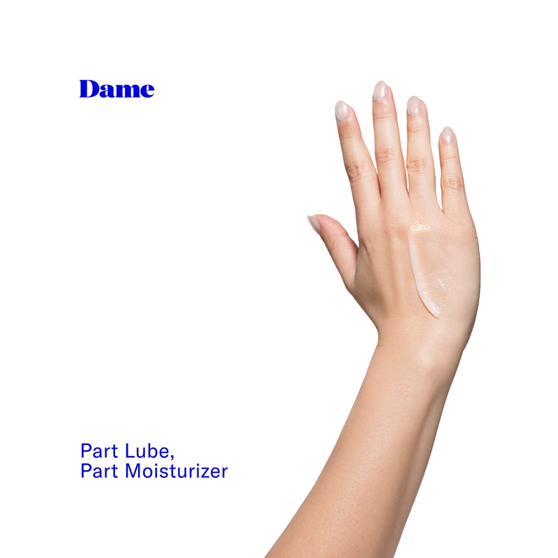 Dame Play Balm dual-purpose moisturizer and personal oil on a hand.