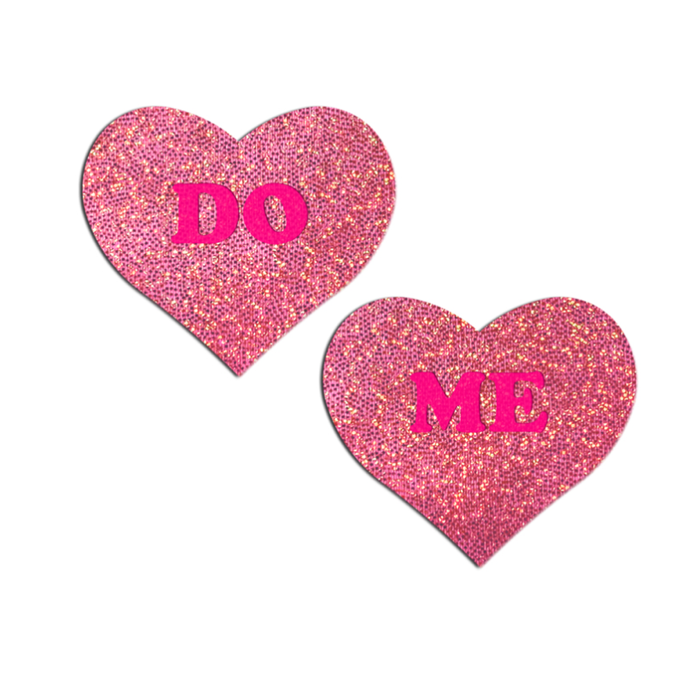 Pink glitter heart nipple pasties with "DO" and "ME" text.