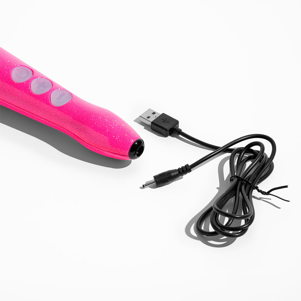 Pink rechargeable wand massager with USB charging cable.