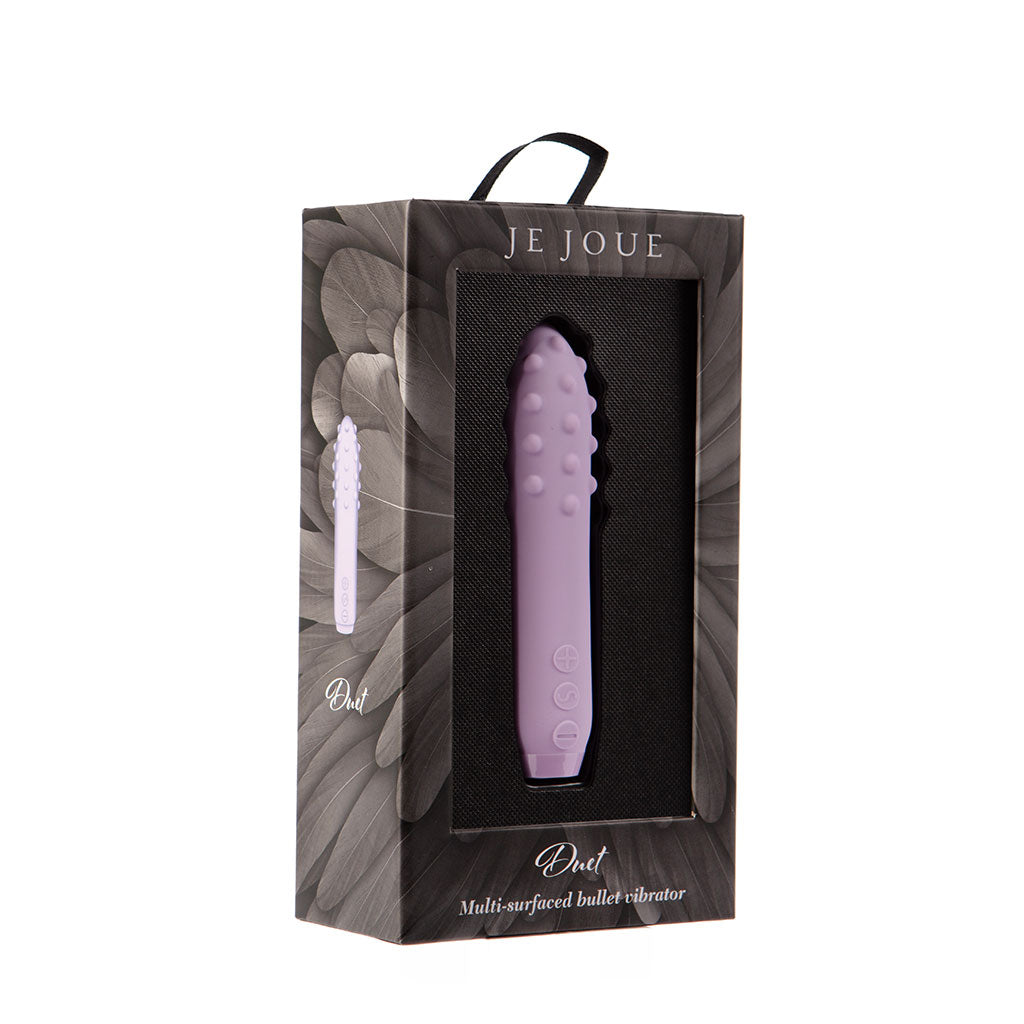 Lilac silicone Duet bullet vibrator by Je Joue in its packaging.