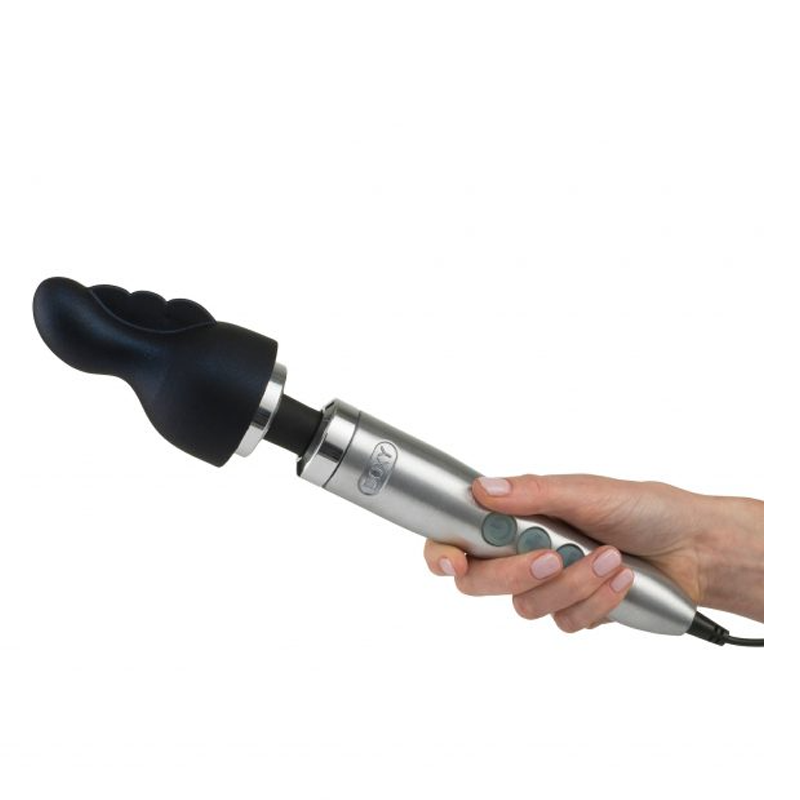 A hand holds a silver wand massager with a black, fluted attachment.