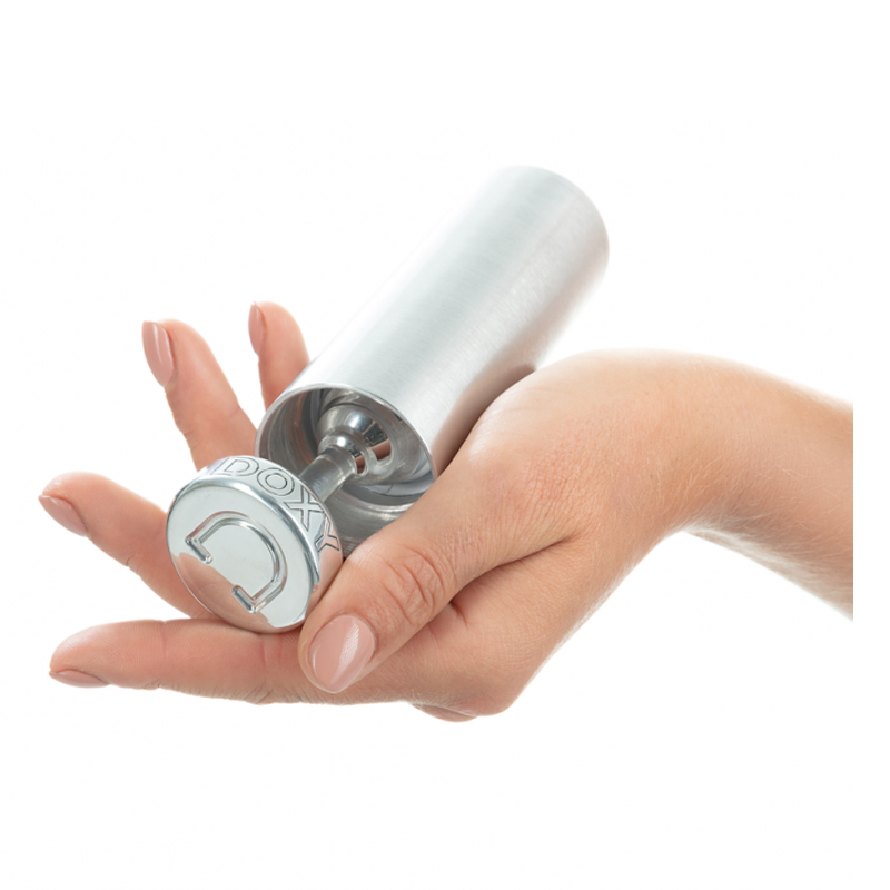 A hand holds a ribbed aluminum butt plug with a weighted design.