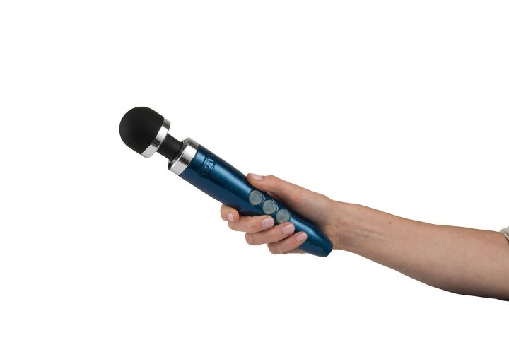 A blue rechargeable wand massager held in a hand.