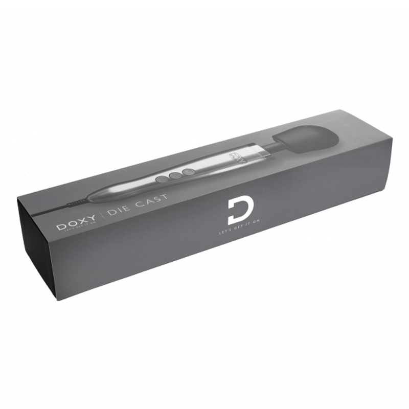 A Doxy Die Cast wand massager in brushed metal on a gray box.