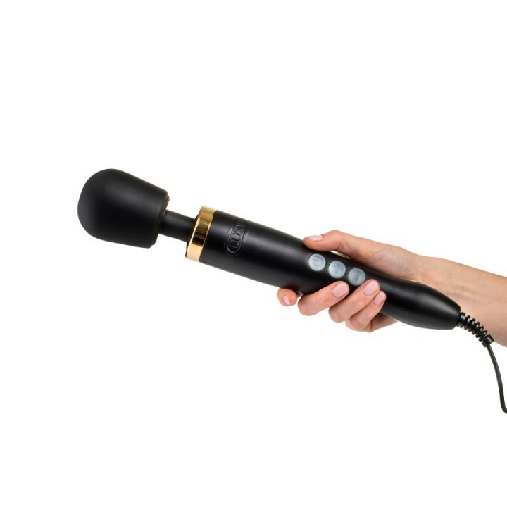 A black and gold Doxy wand massager held in a hand.