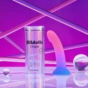 A pink and blue gradient curved dildo with a suction base in a clear cylinder.