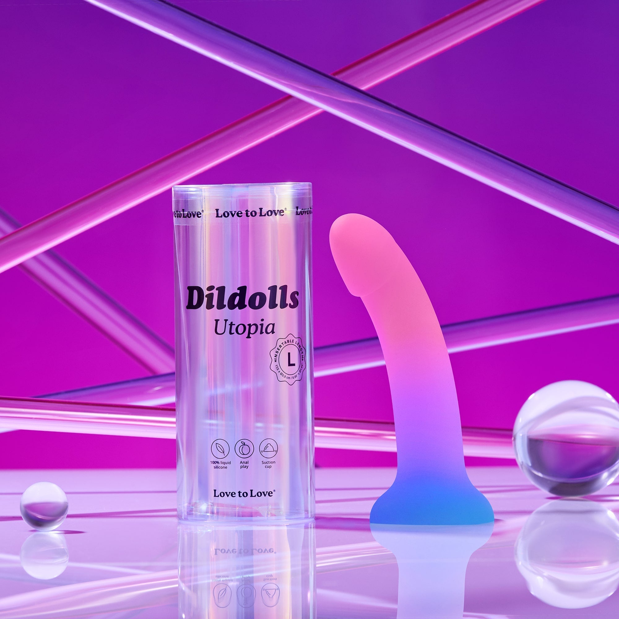 A pink and blue gradient curved dildo with a suction base in a clear cylinder.