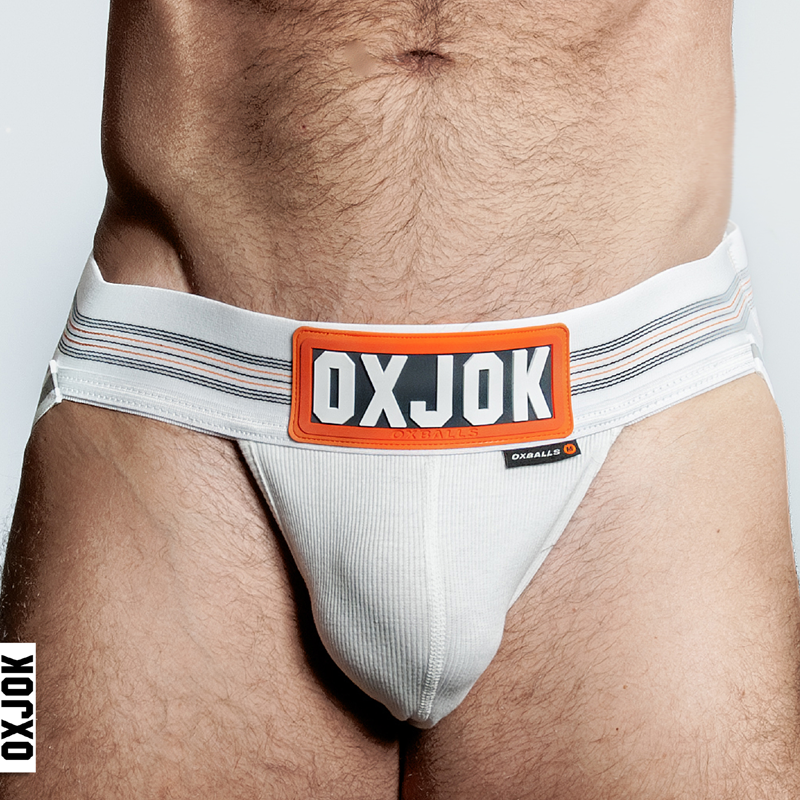 White Oxballs jockstrap with orange and black striped waistband and a prominent OXJOK logo.