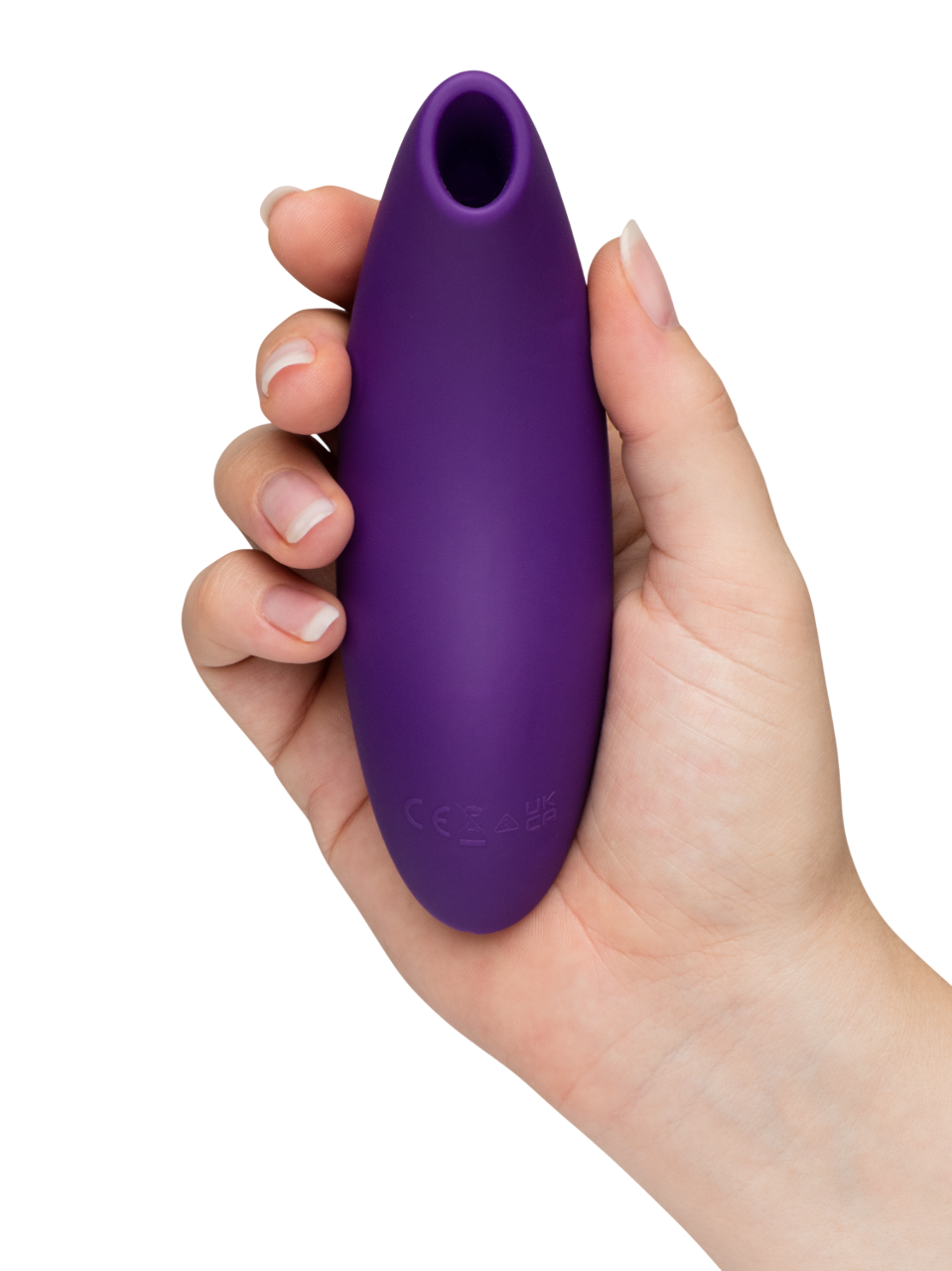 A purple clitoral stimulator held in a hand.