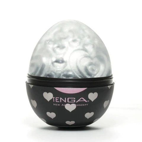 Tenga Lovers Male Pleasure Sleeve in an egg-shaped case with hearts.