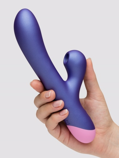 A purple rabbit vibrator with a pink tip held in a hand.