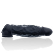 Black silicone cocksheath with cock sling, featuring textured veins and flared head.