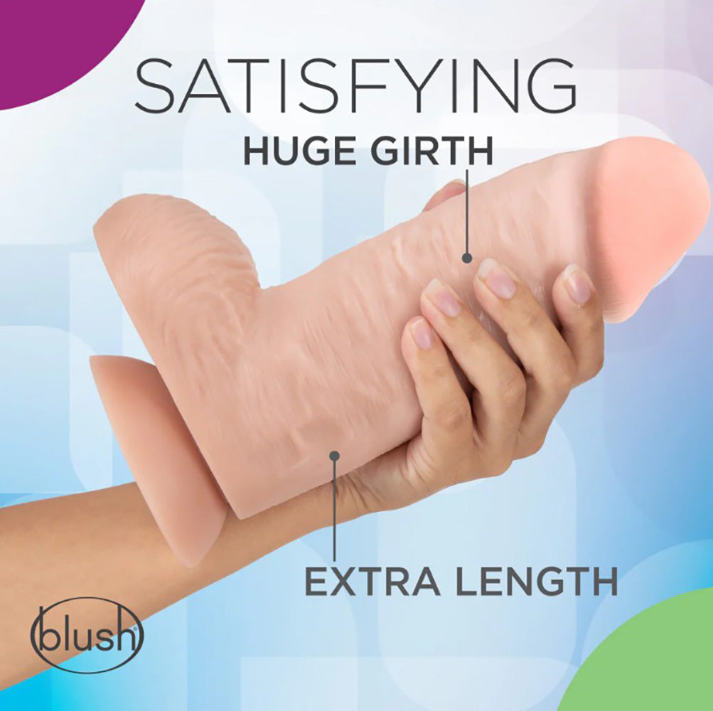 A large, realistic pink dildo with a suction cup base held by a hand.
