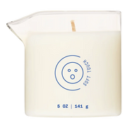 A white massage oil candle in a glass container with a blue logo.