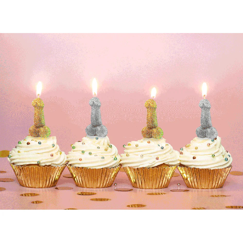 Four glitter penis-shaped candles in gold and silver on cupcakes.