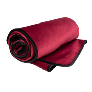 Rolled up merlot king size waterproof microvelvet throw blanket with black trim.